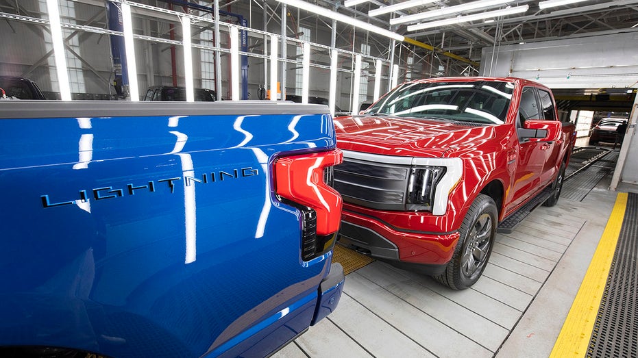 A blue and red Ford F-150 Lightning all-electric truck