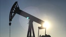 94b1f4cb-An oil rig drilling a well at sunrise near Midland, Texas