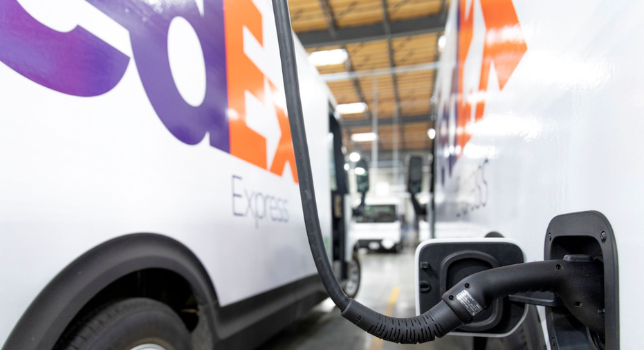 FedEx electric delivery van charging in a warehouse