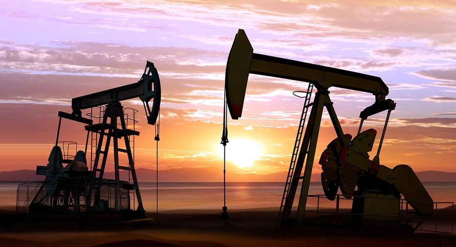 Oil wells at sunset