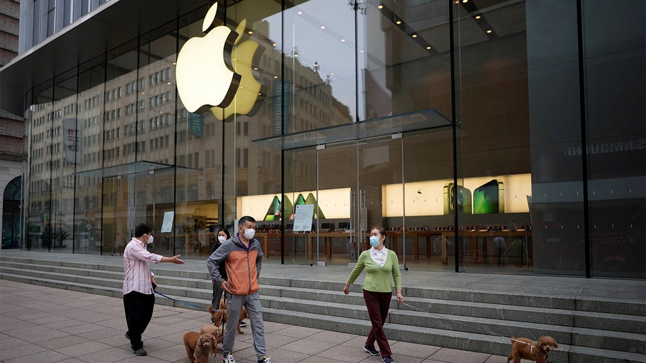 People walk by an Apple store in Shanghai