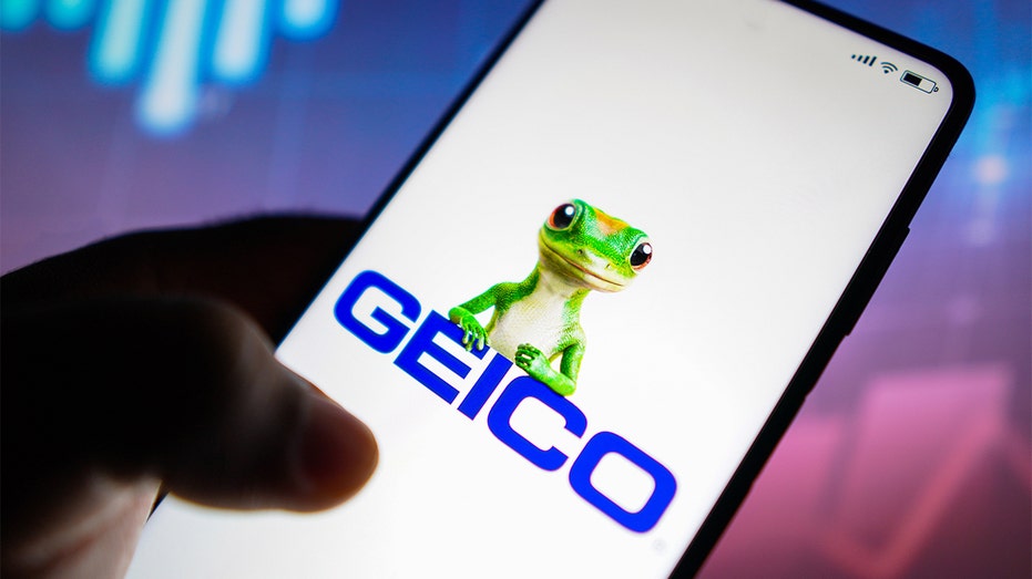 GEICO logo is seen on a smartphone