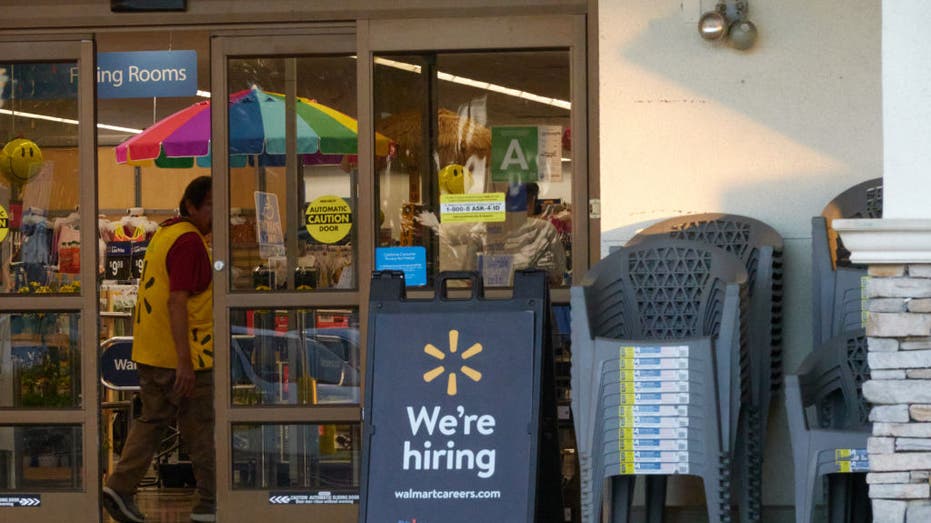 "We're hiring" sign outside of a Walmart store