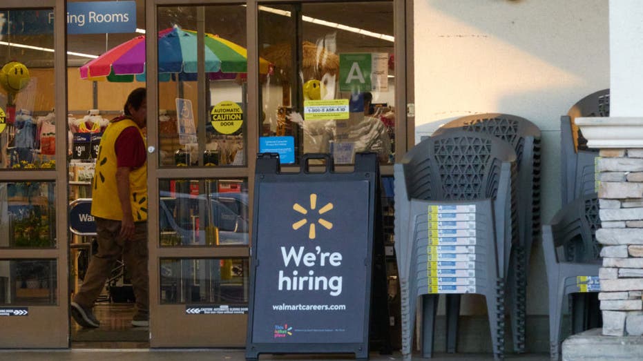 "We're hiring" sign outside of a Walmart store