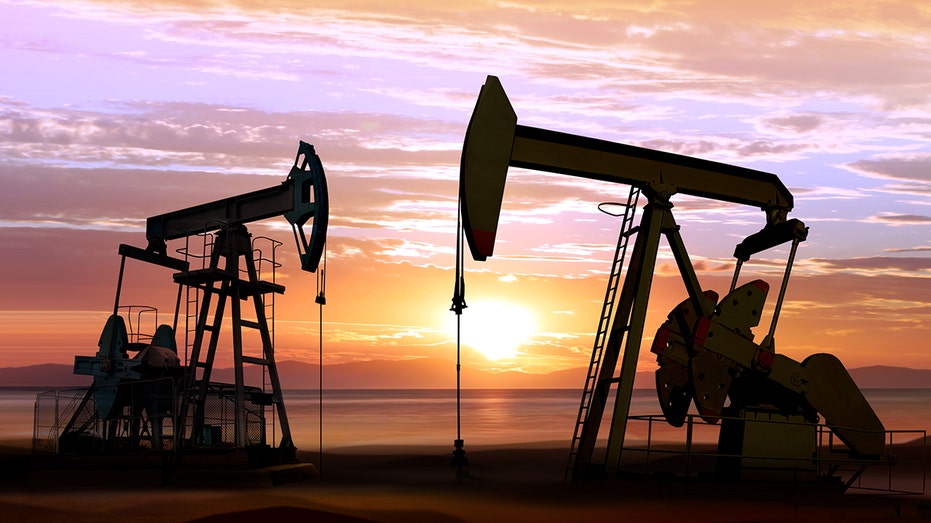 oil wells with sunset background