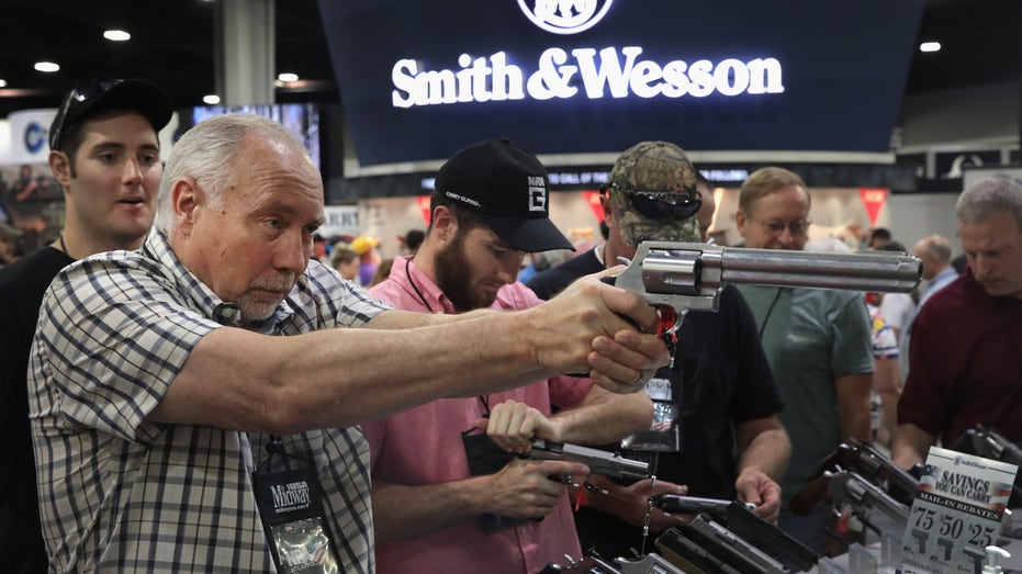 NRA member holding Smith & Wesson pistol