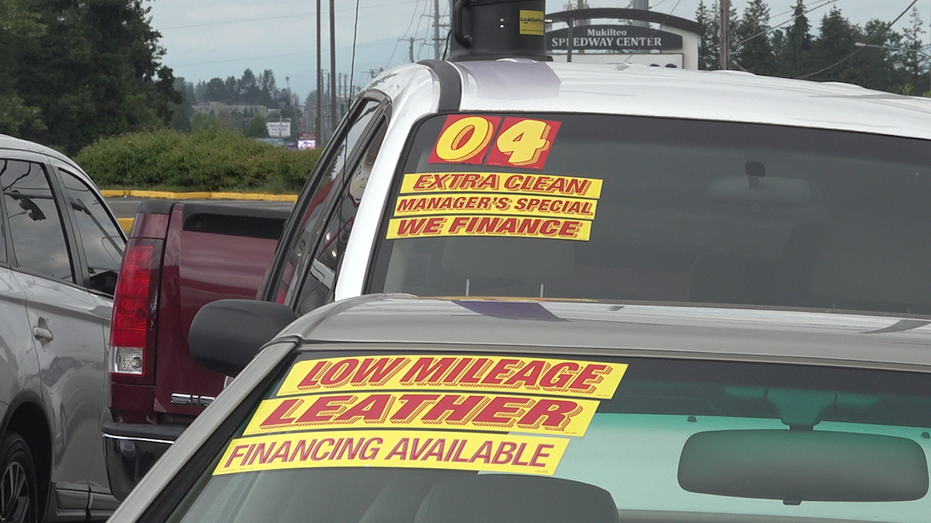 Stickers on used cars at a dealership in Washington state