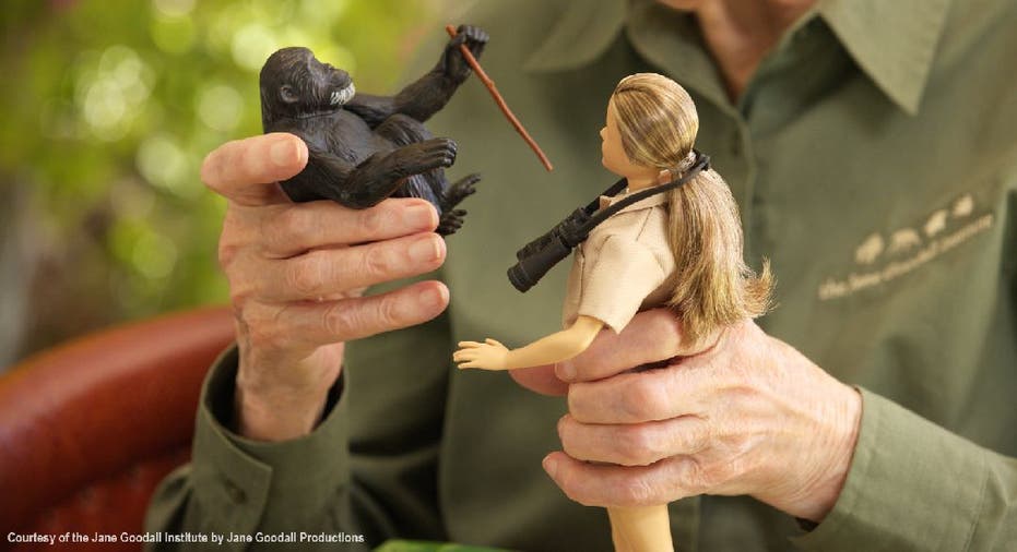 Jane Goodall holds Barbie doll and toy chimpanzee