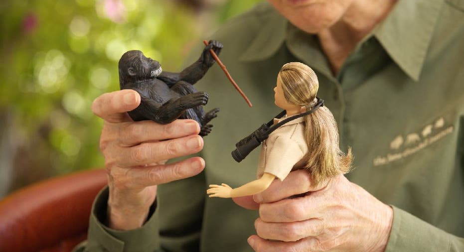 Jane Goodall holds Barbie doll and toy chimpanzee