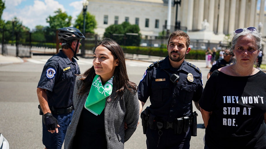 Alexandria Ocasio-Cortez escorted by police from protest