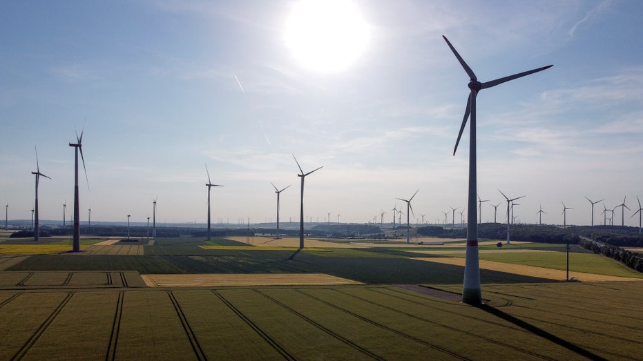 Sun shining on turbines