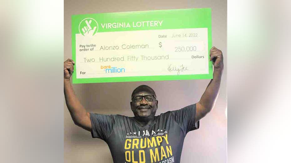 Alonzo Coleman holds his lottery check