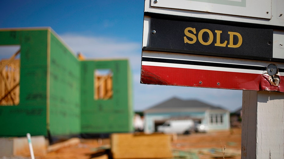 Sold sign in front of new home construction