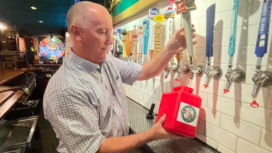 Pat Hughes of Scruffy Duffy's filling.a gallon gas can with beer
