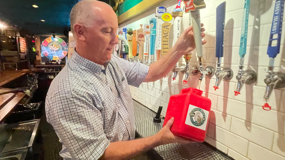 Pat Hughes of Scruffy Duffy's filling.a gallon gas can with beer