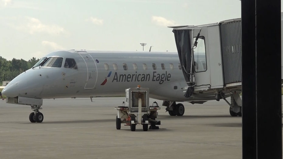 An American Airlines plane sitting at a gate
