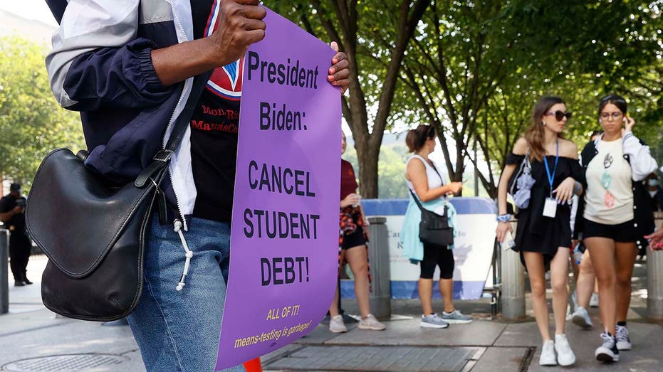 Student loan debt protestor sign