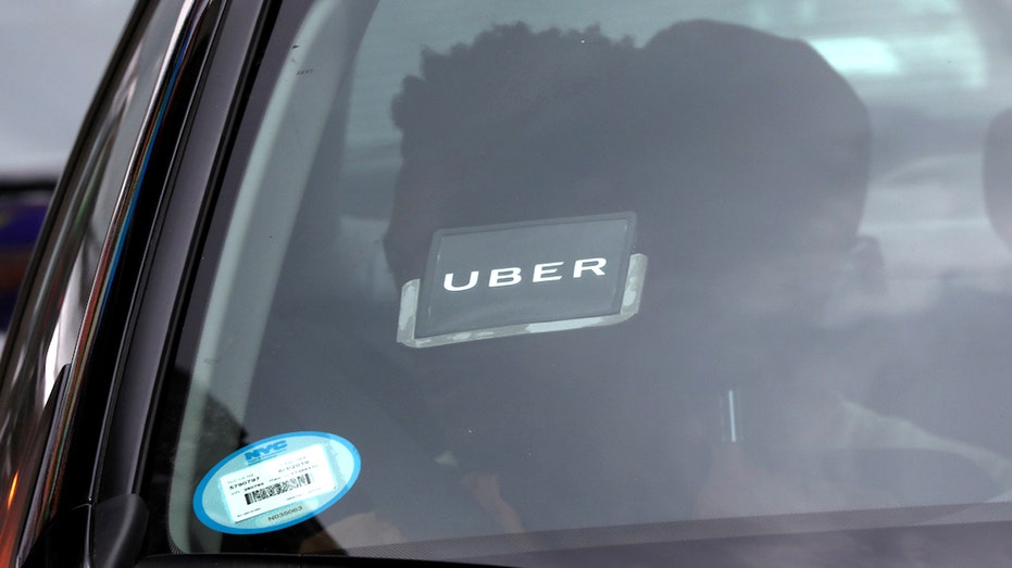 An Uber sticker is seen in windshield of a car