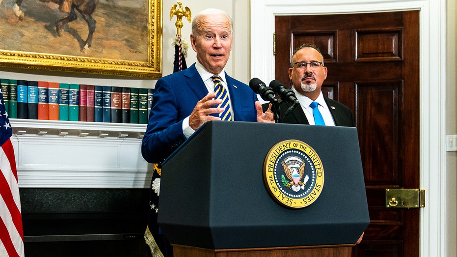 Biden stands on the presidential podium