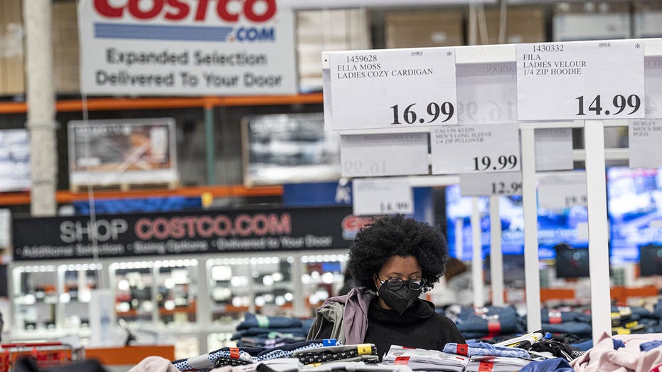 Costco customer wears mask as she looks through clothing