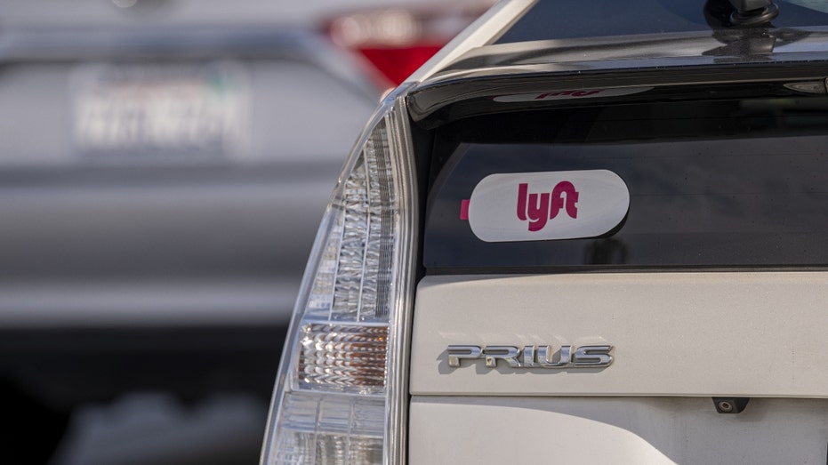 A Lyft sticker on a white vehicle