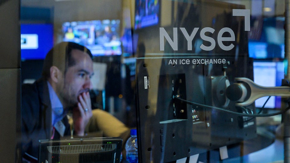 NYSE trader checks the data