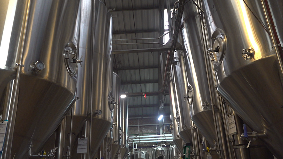A row of large beer tanks used for the brewing process