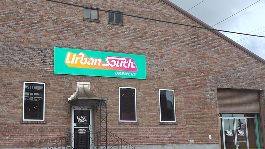 Outside shot of brick building with sign that says Urban South Brewery