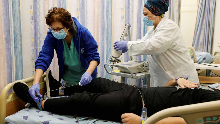 Doctors examine covid patient