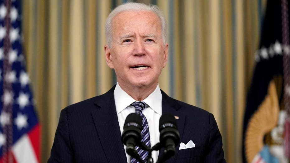 President Biden speaking at a podium with two microphones