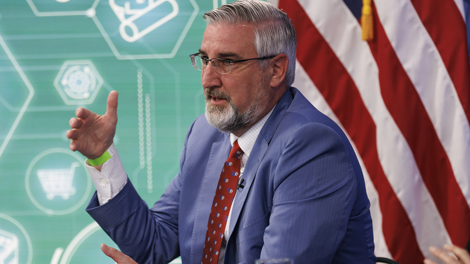 photo of Indiana Gov. Eric Holcomb speaking at event with President Biden