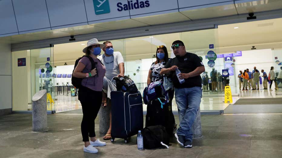 Passengers wait to board plane