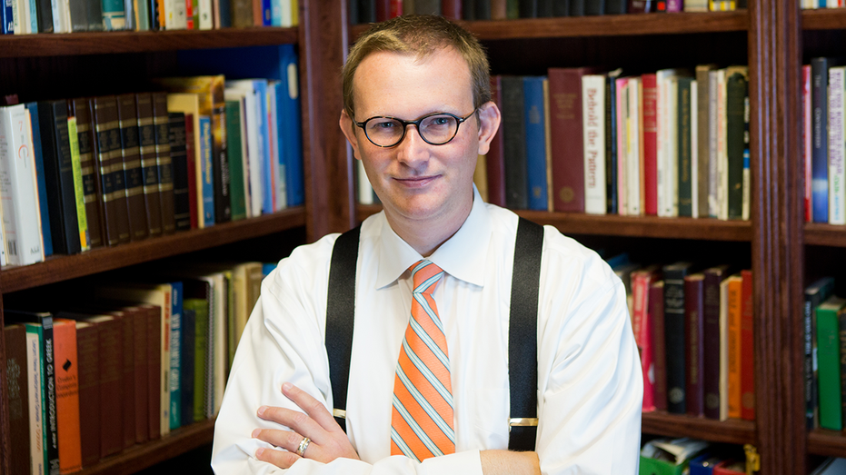 Troy University Professor Allen Mendenhall in a dress shirt with suspenders