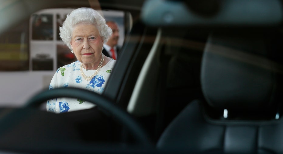 Queen Elizabeth peers through the window of a Range Rover