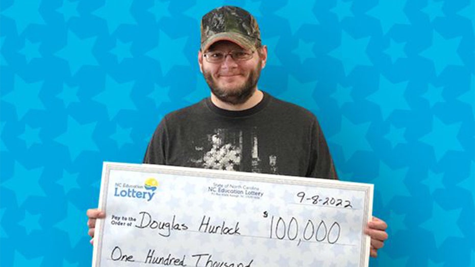 Douglas Hurlock and his lottery check