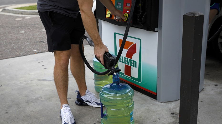 A man pumps gas in Tampa, Florida ahead of Hurricane Ian's landfall