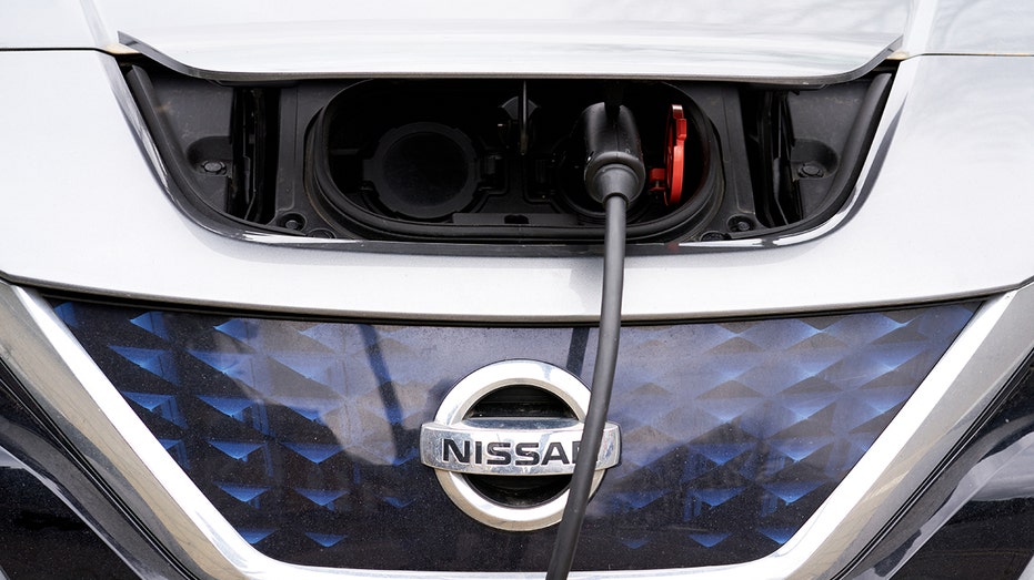 A zoomed in photo of a Nissan Leaf car