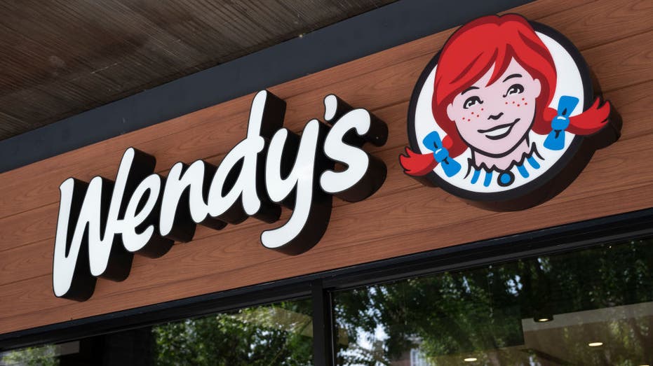 Wendy's sign on a dark wood background