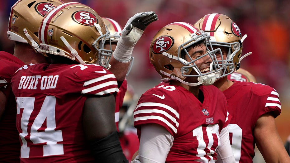 Jimmy Garoppolo reacts after scoring a touchdown