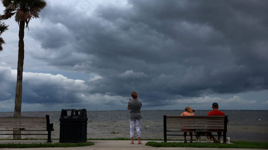 A Florida man looks out over the ocean ahead of Hurricane Yan