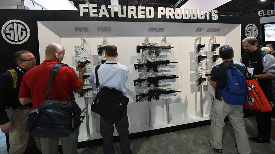 Customers look at featured SIG Sauer firearms