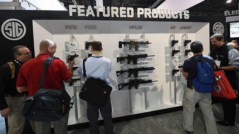 Customers look at featured SIG Sauer firearms