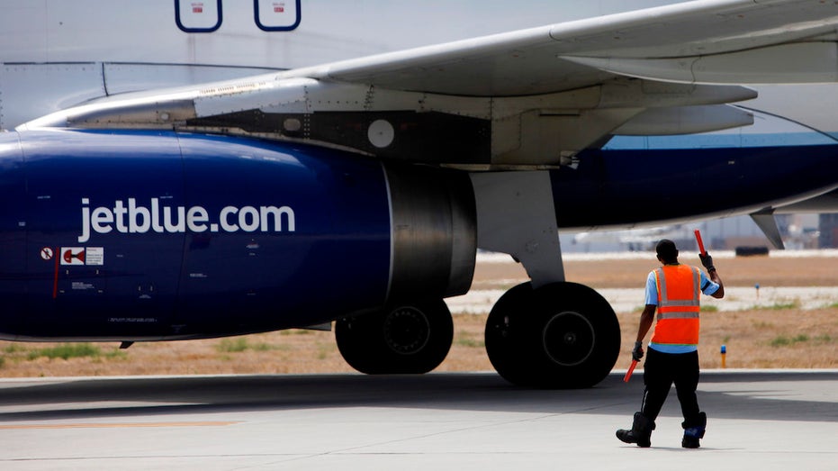 JetBlue ground crew directing aircraft