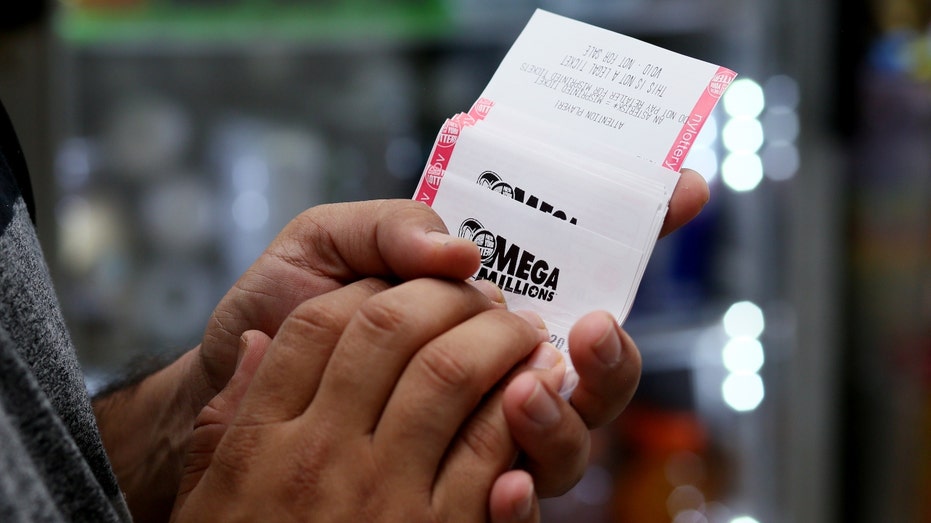 Person holding Mega Millions ticket