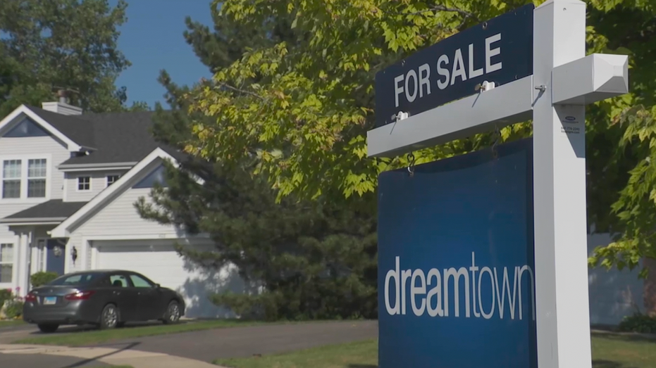 A For Sale sign from the real estate company dreamtown stands outside a home