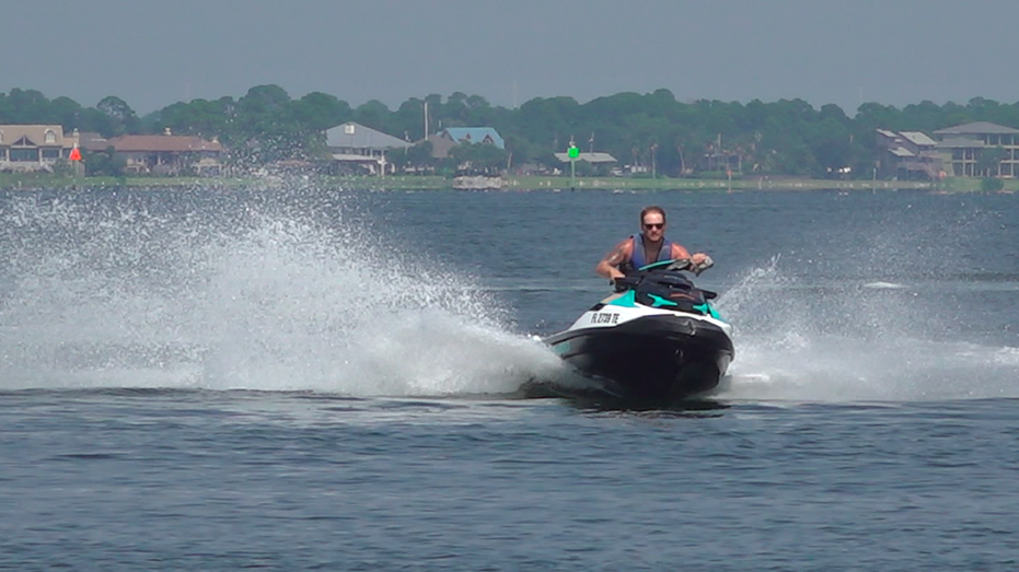 Man on jet ski spraying water