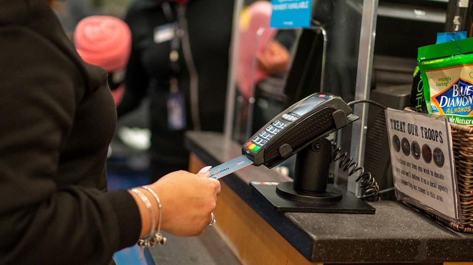 A woman paying with a credit card