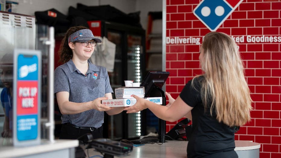 Domino's works hands over pizza