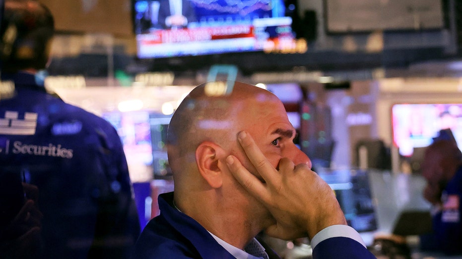 Traders work on the floor