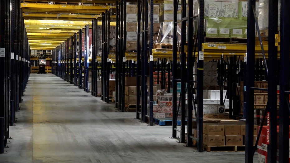 Bottles of spirits and wine sit inside of a warehouse